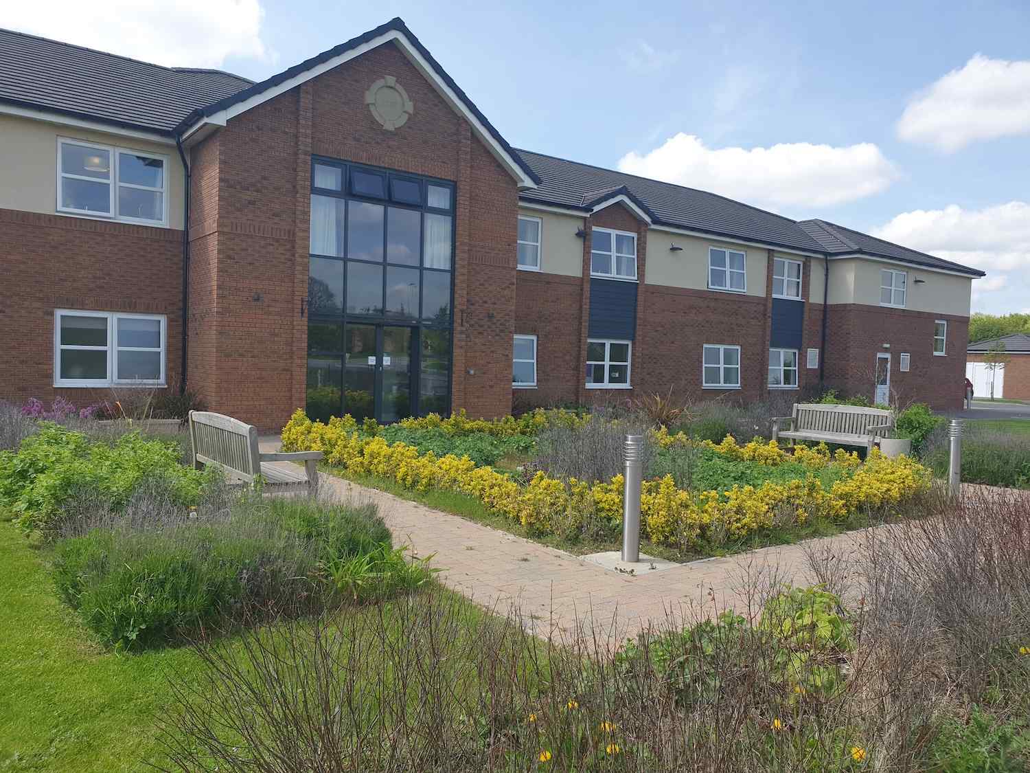 exterior of our home with plants and grass area