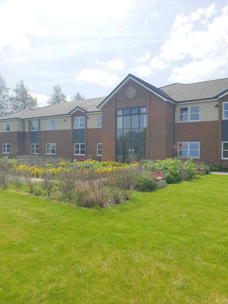 exterior of our home with plants and grass area
